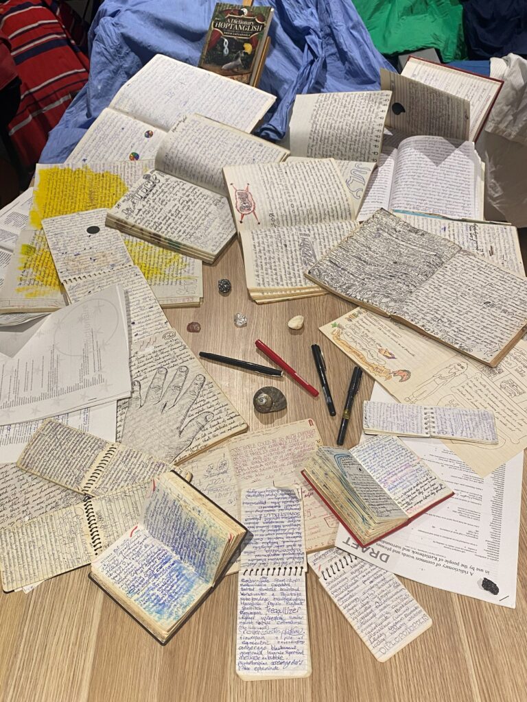 David’s handwritten Hoptanglish notebooks spread across a table